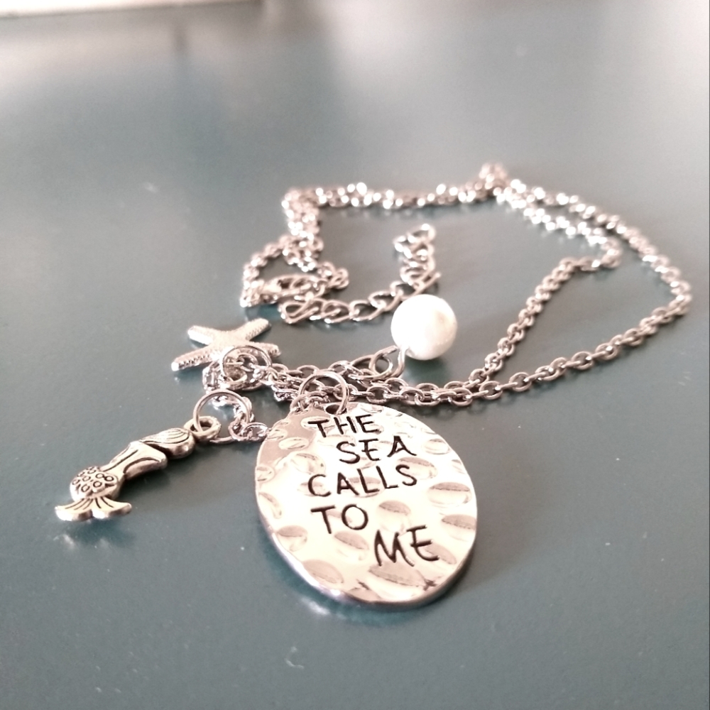 The Sea Calls Me Pendant Necklace Adjustable 20" to 22" long. Silvertone.